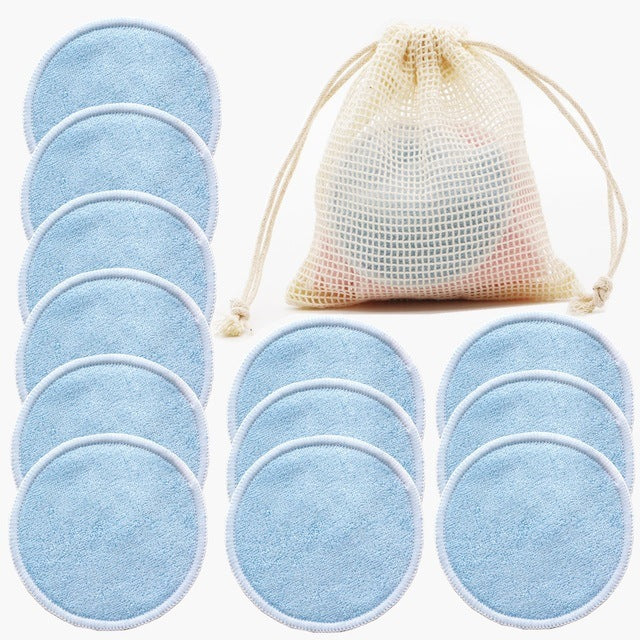 Set of blue reusable makeup pads with a mesh storage bag on a white background