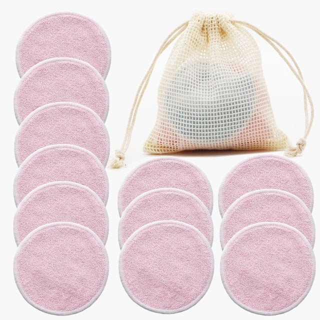 Pink reusable makeup pads with a drawstring bag on a white background