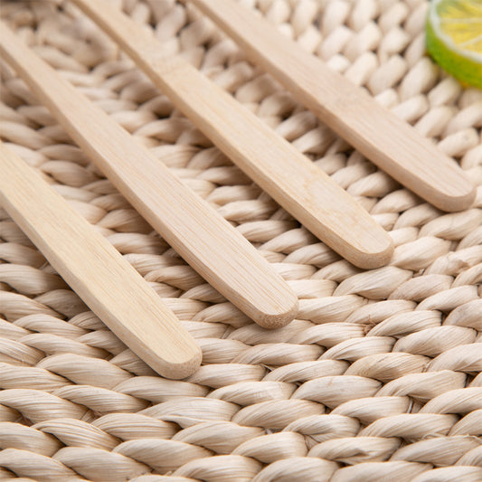 Wooden popsicle sticks on a woven surface